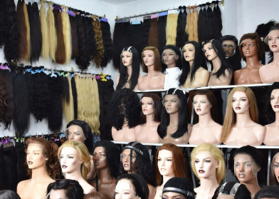 Diverse range of premium human hair wigs on display in a modern Qingdao wig factory